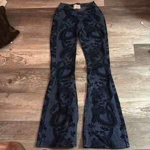 Black and blue dragon print,  v- shaped waist line; flare jeans